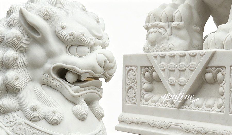 Close-up view of carved details on white marble Chinese guardian lion foo dog statue, showing intricate patterns and facial features