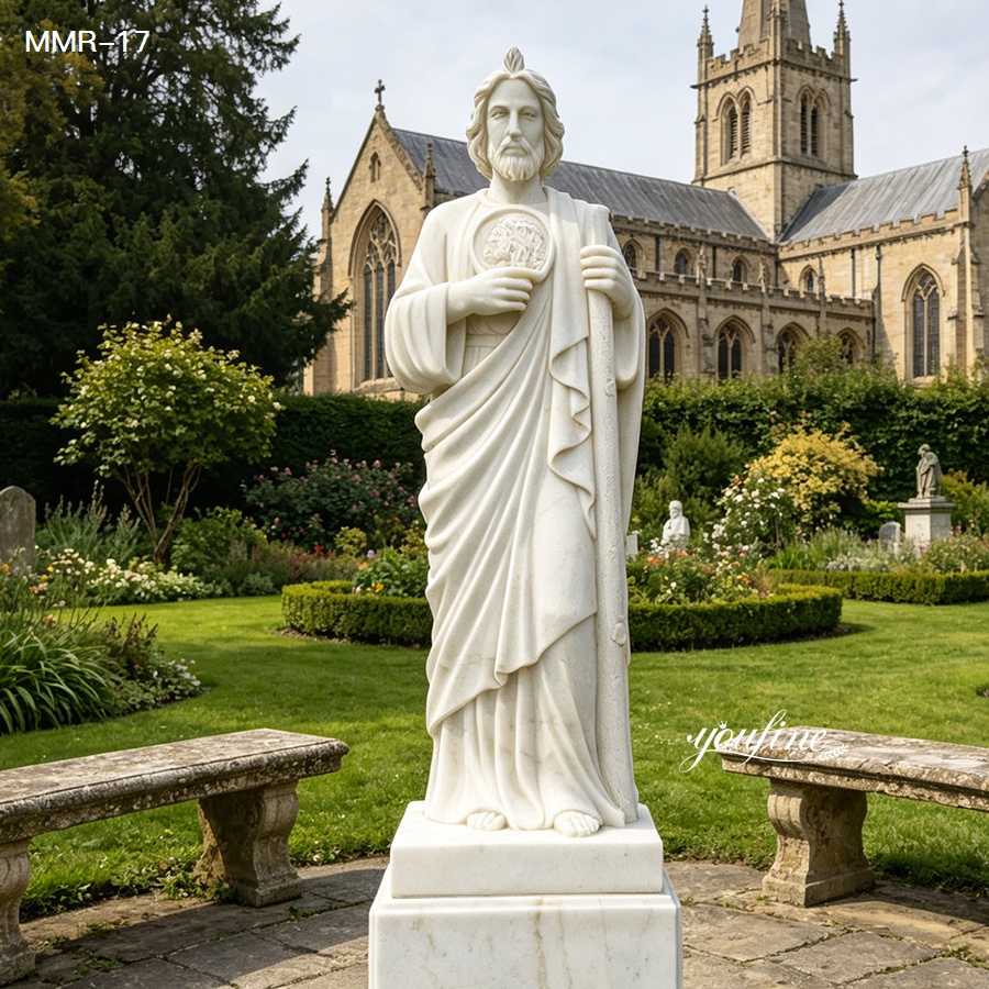 Classic hand-carved marble St. Jude statue standing in a lush green church garden, showcasing the elegant design of the patron saint statue.