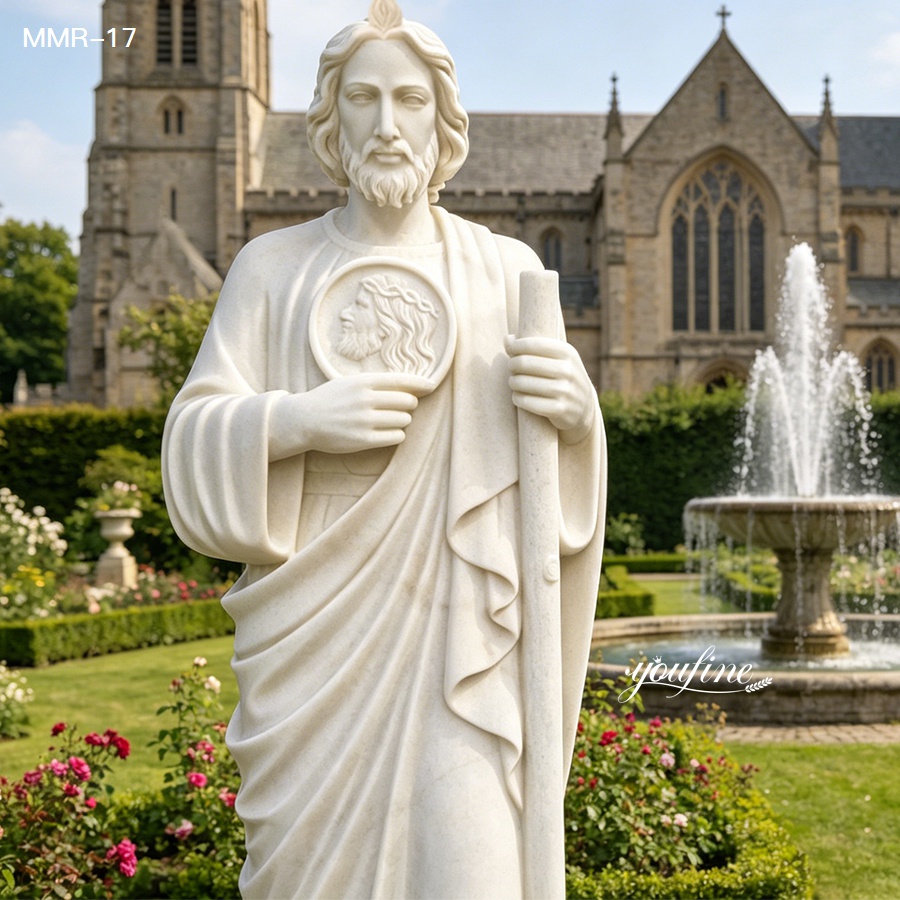 Close-up of a marble St. Jude statue in a blooming garden, highlighting the smooth texture of the high-quality marble and detailed carvings.