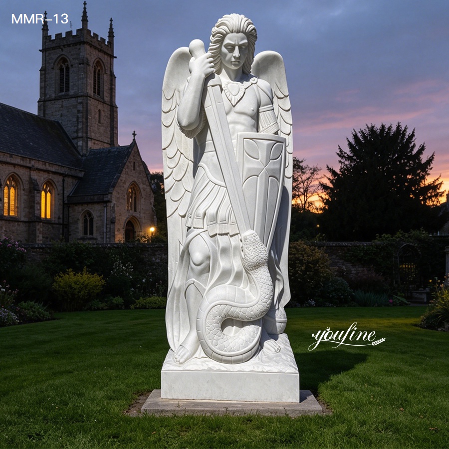 St Michael the Archangel marble statue with detailed wings, set against a church backdrop at dusk