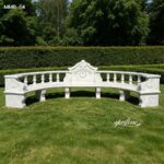 Elegant white marble garden bench with curved backrest, relief carvings, and column details