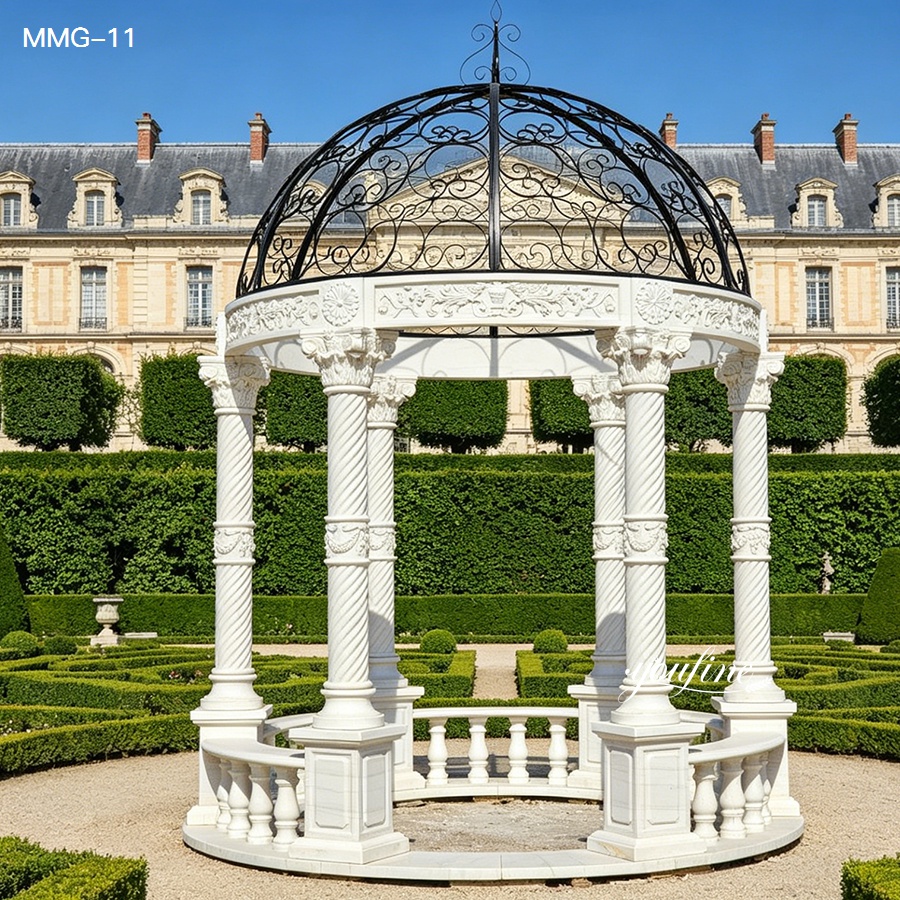 Full view of a large round white marble gazebo with twisted columns and black wrought iron dome, perfect for garden and courtyard