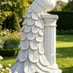 Close-up of white marble peacock flower pot with hand-carved feather details