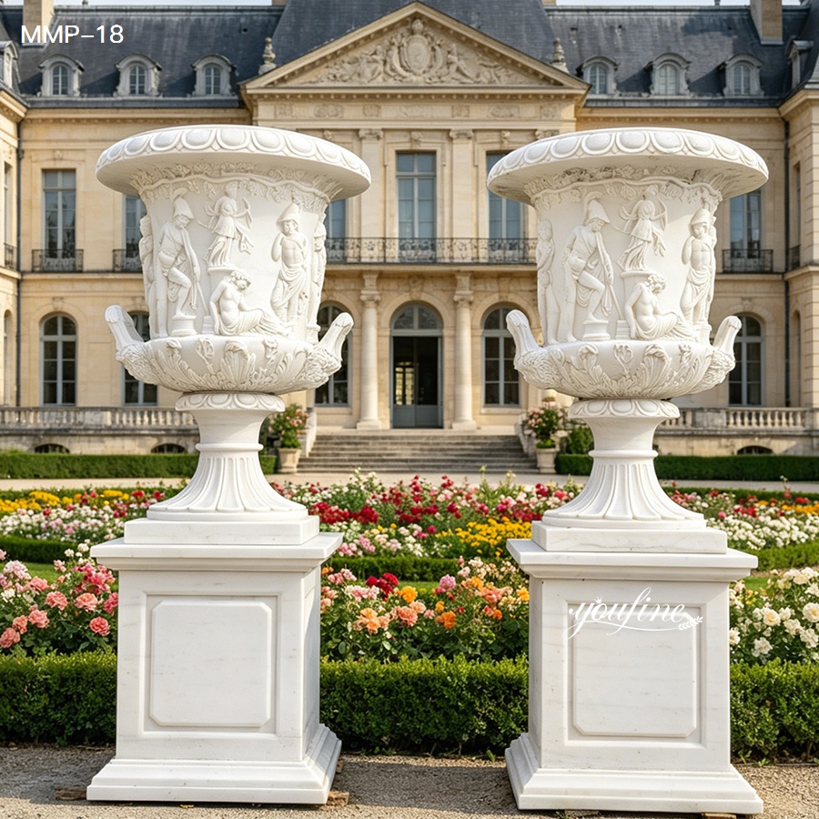 Large marble urn planters in classic European style garden