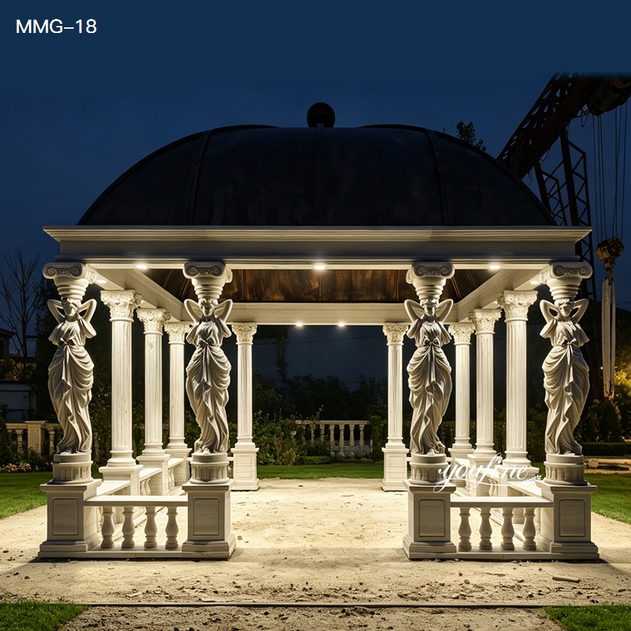 Night view of the square white marble gazebo with soft lighting highlighting the caryatid columns and copper roof.