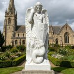 St Michael the Archangel marble statue in a landscaped church garden, symbolizing the triumph of good over evil