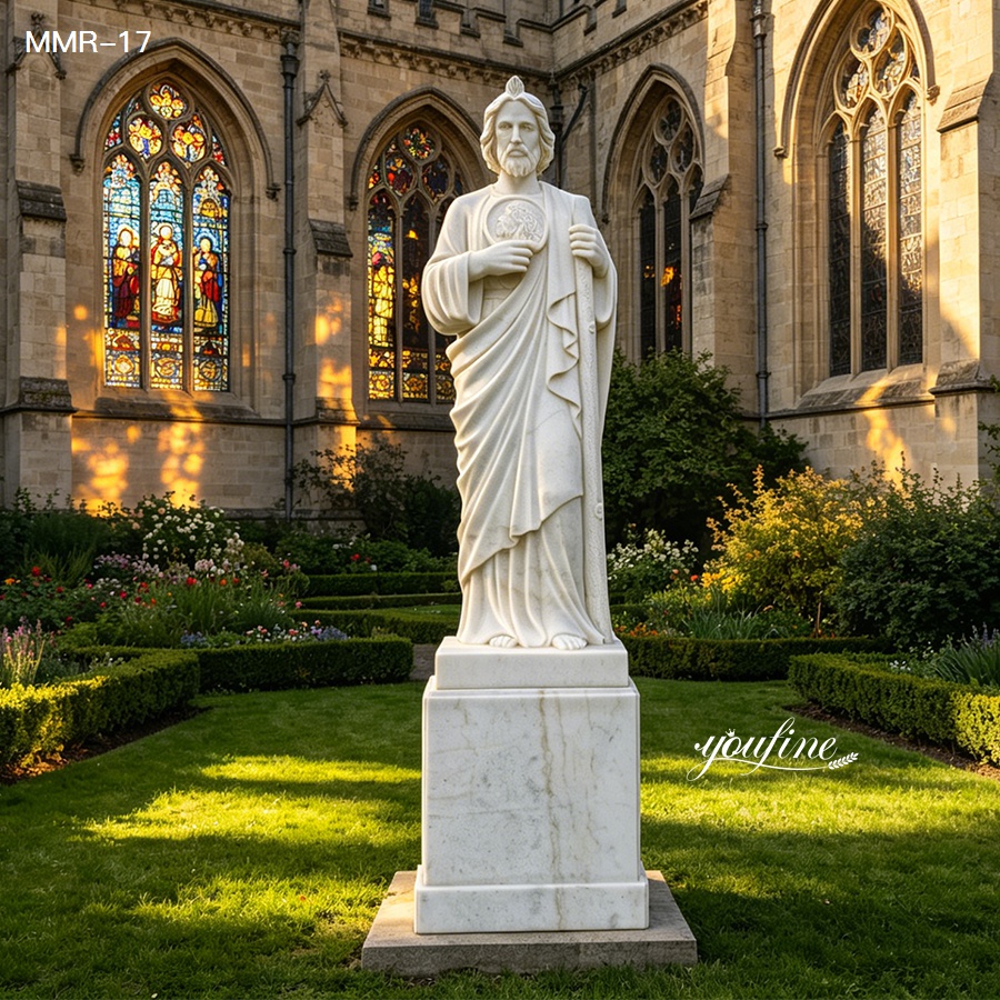 Sunlit view of a marble St. Jude statue in a church garden, with colorful stained glass windows in the background.