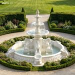 white three tier marble horse fountain in a garden courtyard