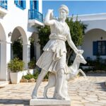 Life-size natural marble Diana of Versailles goddess statue with deer, hand-carved outdoor sculpture for white-walled Mediterranean courtyard