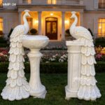 White marble peacock flower pot statue placed in a luxury garden landscape