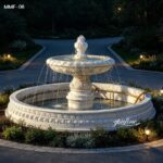 one tier white marble fountain in outdoor garden at dusk