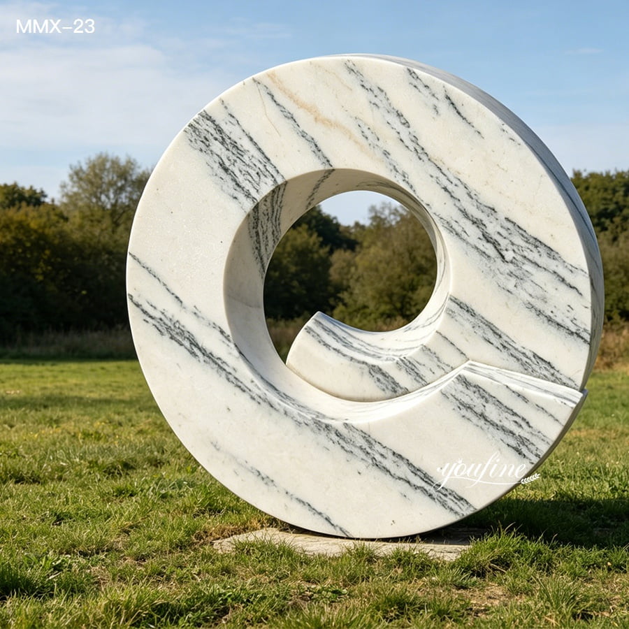 Abstract circular marble sculpture with natural grey veining, contemporary outdoor art