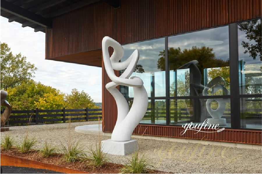 Abstract twisting white marble sculpture in semi-outdoor patio setting