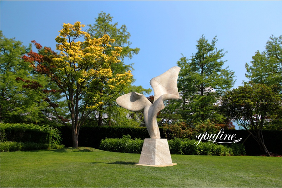 Abstract wing-shaped stone sculpture in park settingt