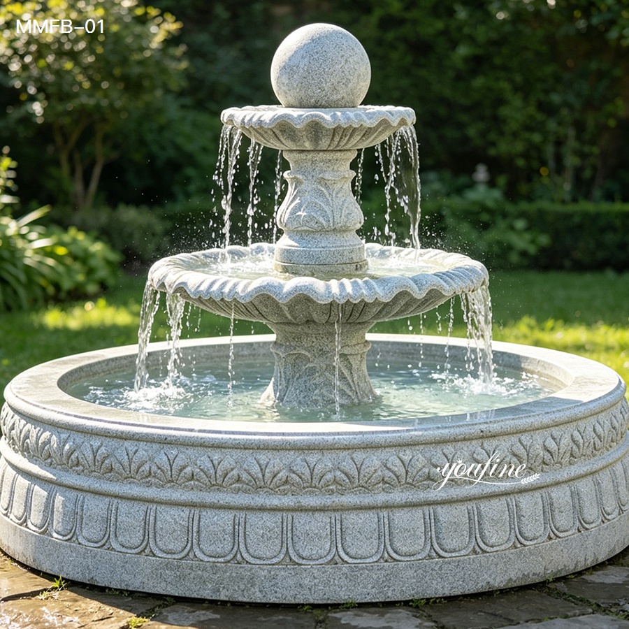 Angled close view of a rolling ball fountain made of natural sesame gray granite.