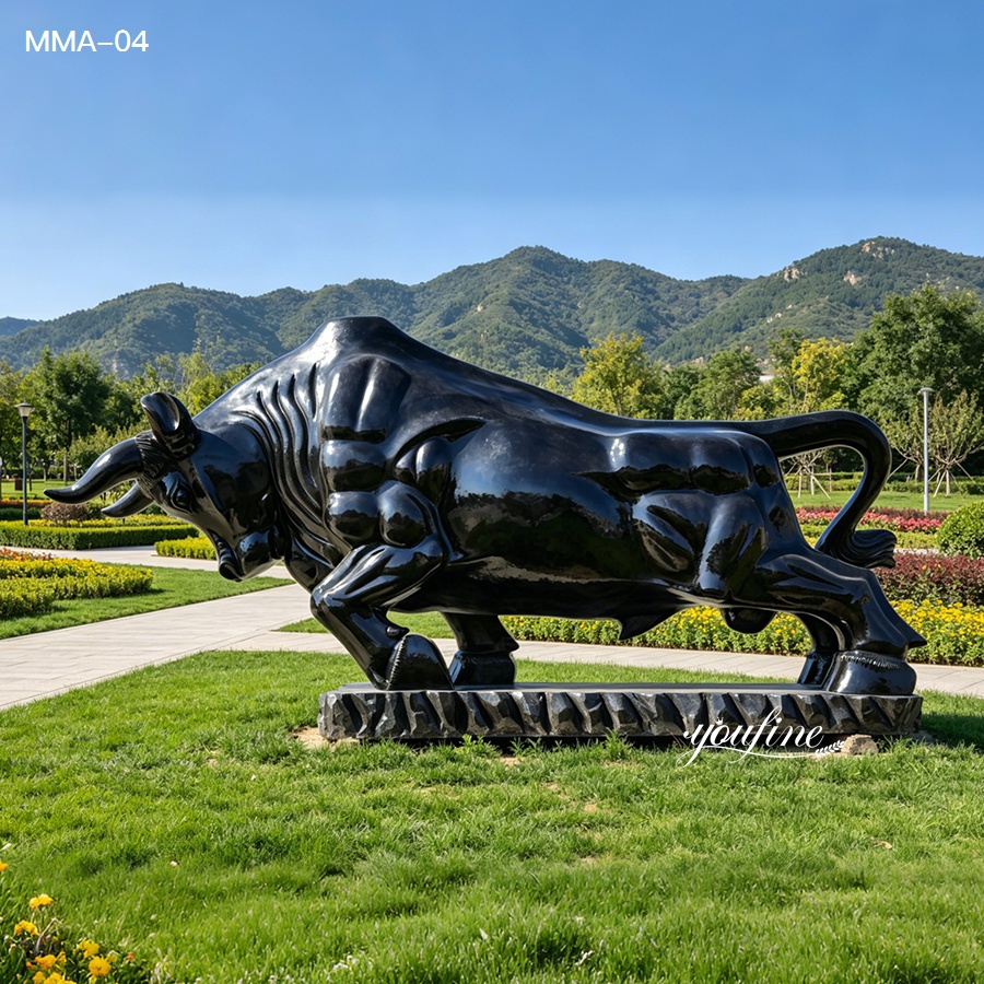Polished black marble bull sculpture installed in a scenic outdoor plaza