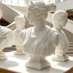 Group view of hand-carved marble bust of Diana the Huntress, multiple statues in gallery setting
