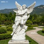 Cupid and psyche marble sculpture installed in a landscaped garden