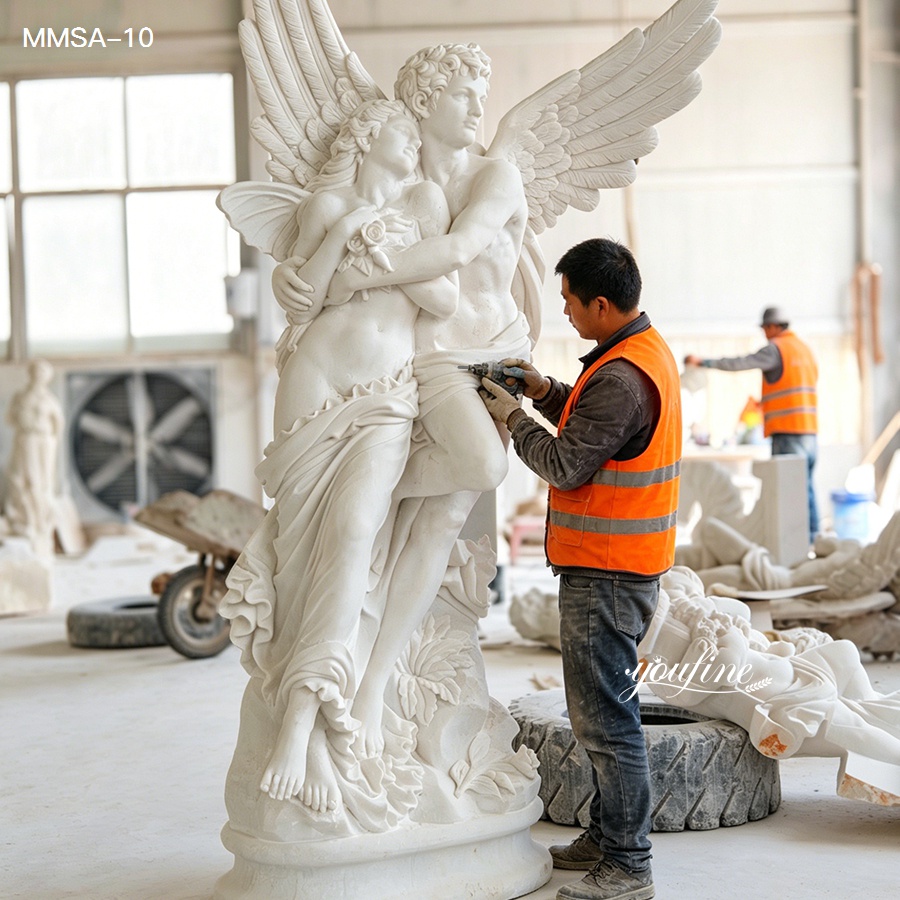 Artisan carving a cupid and psyche marble sculpture in the workshop