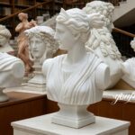 Collection of marble busts including Diana the Huntress, gallery display with classical statues