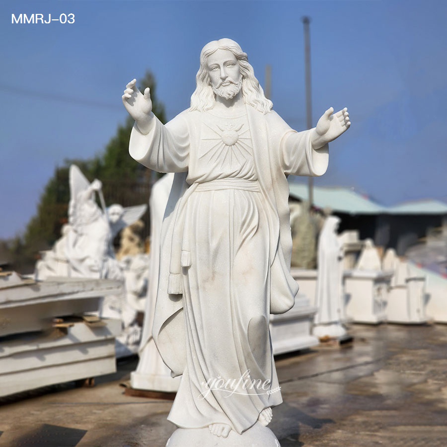 front angle view of white marble Jesus statue under blue sky