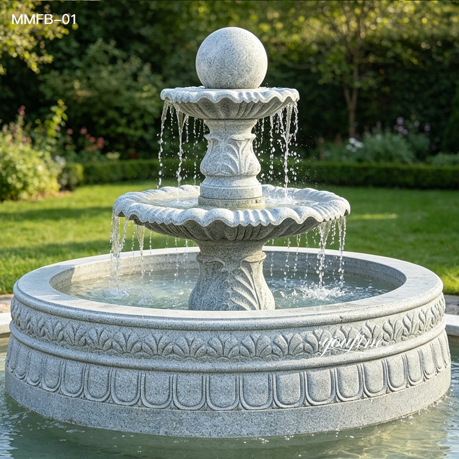 Front view of a sesame gray granite rolling ball fountain with carved basin and double wave tiers.