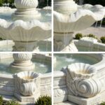 Close-up details of floral carving and flowing water on marble fountain