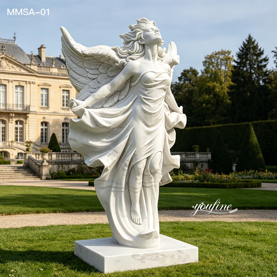 Classic white marble angel sculpture with detailed wings and billowing dress in a landscaped garden