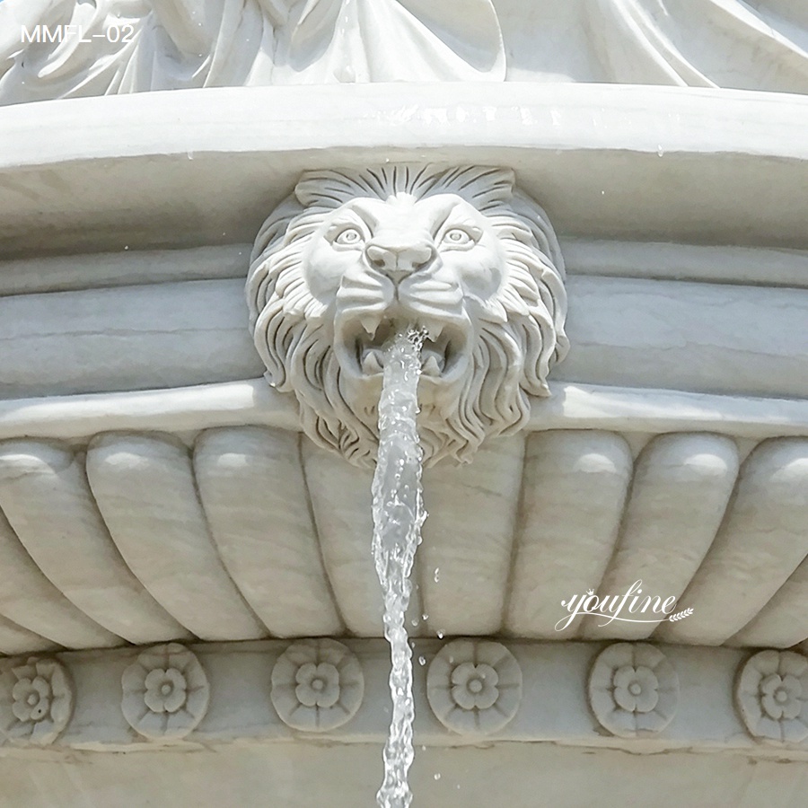 Close-up of lion head water outlet on the basin of a marble outdoor fountain.