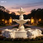 Two tiered natural marble fountain with elegant water flow at sunset