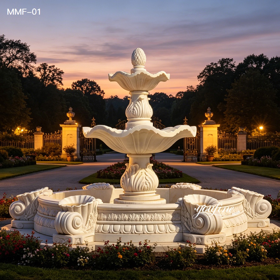 Two tiered natural marble fountain with elegant water flow at sunset