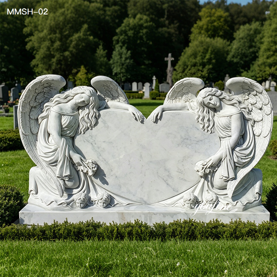 Kneeling angels marble heart headstone in a peaceful cemetery setting