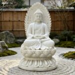 natural white marble buddha statue in dry zen garden, raked sand background, lotus base, detailed carving