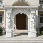 Custom Italian marble door frame with arched top, installed on a light-colored house facade