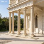 Real photo of natural beige marble pillars for sale, full-size tapered columns installed on a classical building facade