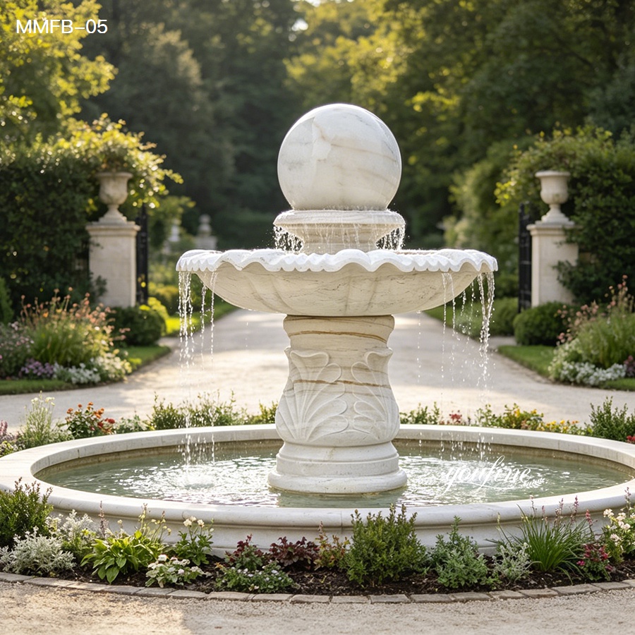 Front view of a white rolling marble ball fountain with rotating top sphere and circular water basin in a garden setting.