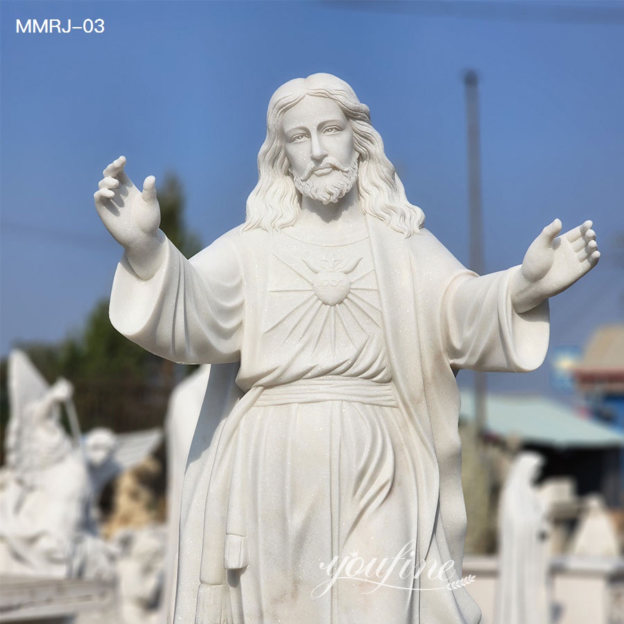 close view of white marble Jesus statue with open arms
