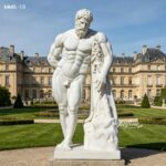 Life-size Farnese Hercules marble sculpture settled on green lawn of classic French manor