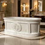 Oval freestanding hand carved marble bathtub with classical European carved details in luxury bath room