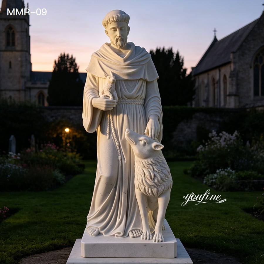 Outdoor marble St Francis of Assisi statue shown in evening light
