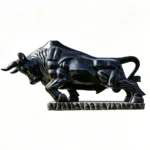 Polished black marble sculpture of a bull in a powerful and dynamic stance on a detailed base, set against a white background.