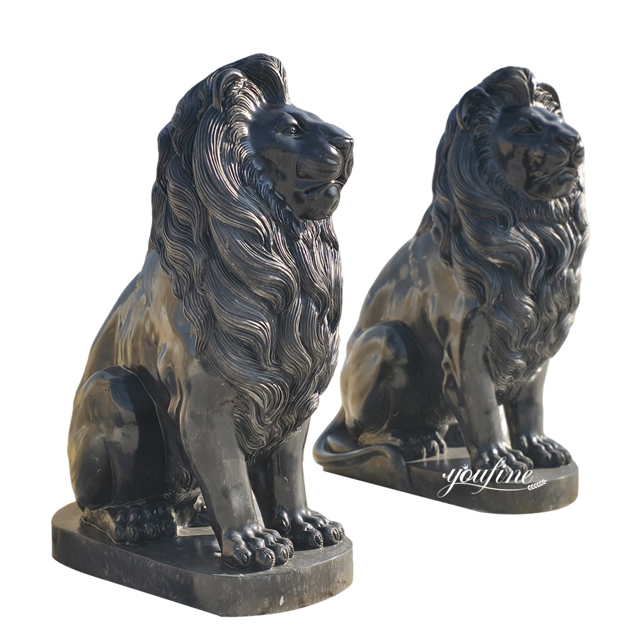 Two intricately carved black marble lion sculptures with regal manes, showcasing craftsmanship and luxury, on pedestal bases.