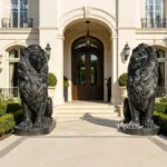 Pair of majestic black marble lion statues placed symmetrically at the entrance of a high-end residential property with ornate architecture.