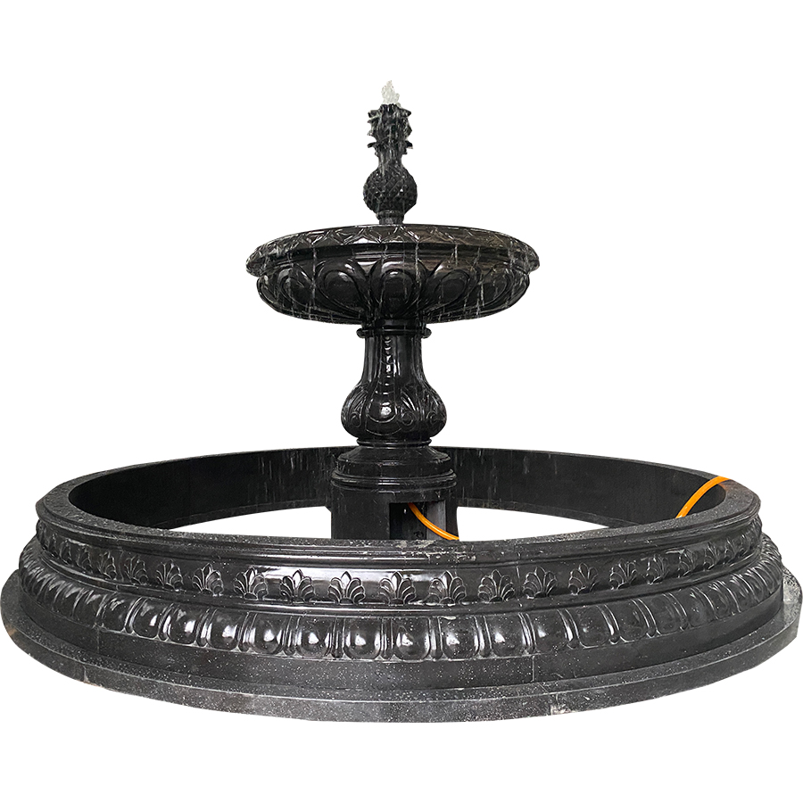 A black marble tiered fountain featuring intricate carvings and a central pineapple design on top, ideal for high-end exteriors.