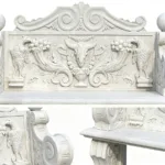 A detailed marble bench featuring carved motifs including birds, a ram's skull, foliage, and ornate patterns, showcasing skilled artistry.