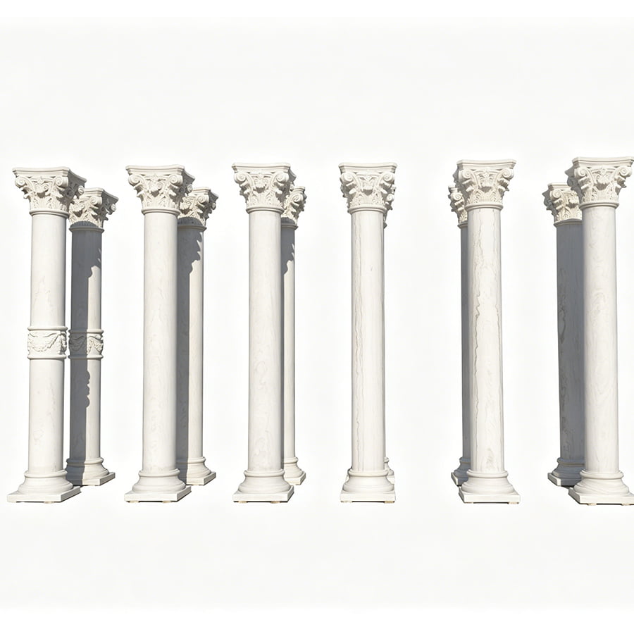 A set of decorative white marble columns with intricately carved capitals, showcasing classical architectural design.