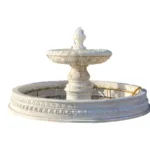 Large tiered marble fountain featuring detailed carvings and circular basin against a white background.