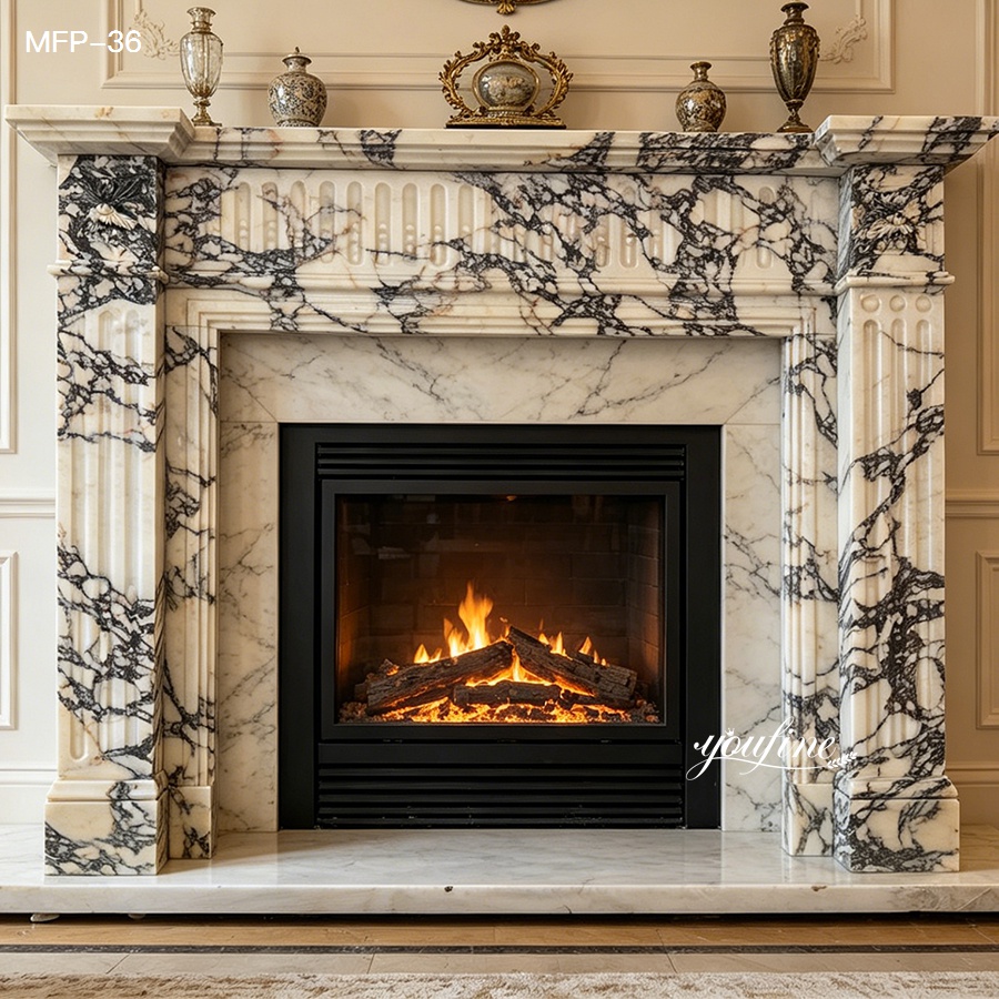 Elegant black and white marble fireplace with ornate detailing and a warm fire burning within, surrounded by classic home decor.