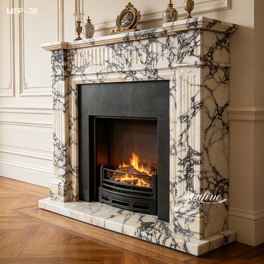 Elegant black and white marble fireplace mantelpiece with carved details and a cozy fire, framed by classic interior décor.