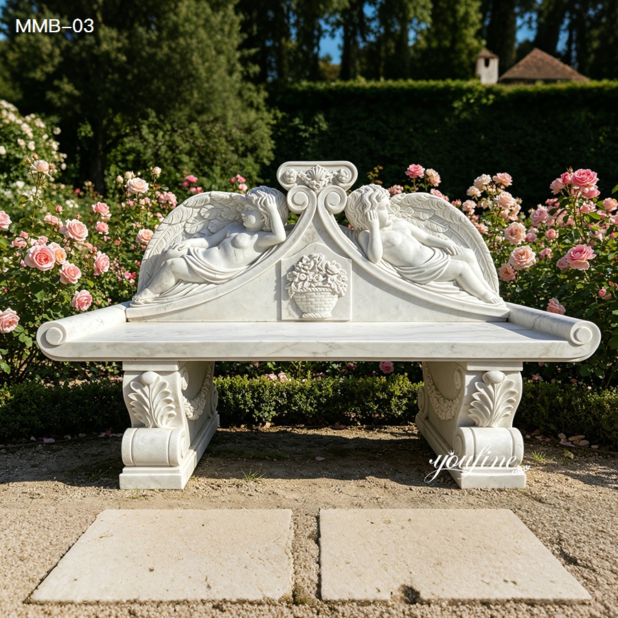 White marble garden bench with intricate angel carvings surrounded by blooming roses in a formal garden setting.